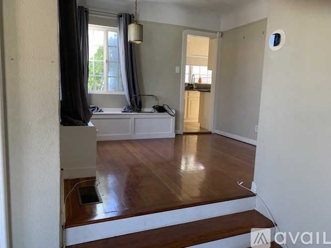 A room with a window and a white sofa.