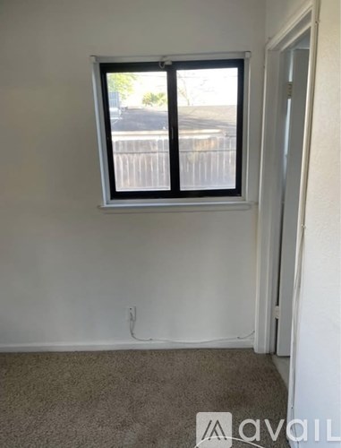 A room with a window and a door.