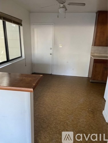 A room with a white door and a window with blinds.