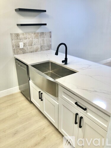 A kitchen with a sink and a countertop.