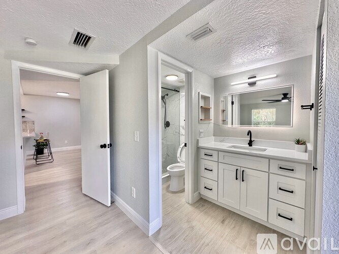 A bathroom with a white sink and a mirror above it.