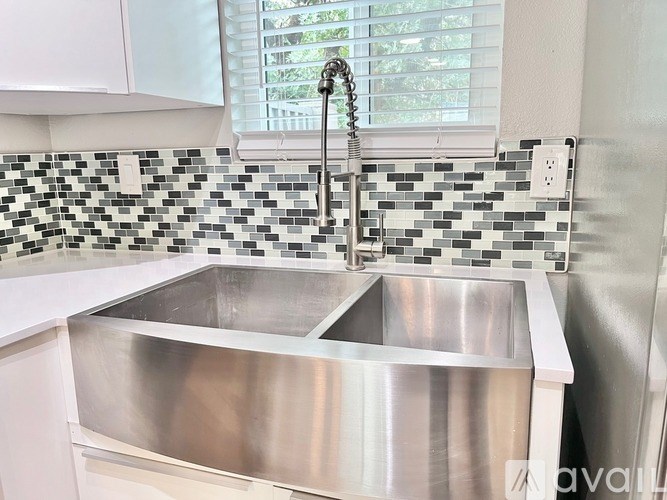 A kitchen with a sink and a window.