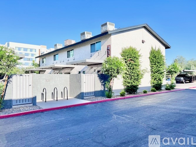 A modern house with a red stripe on the side of the driveway.