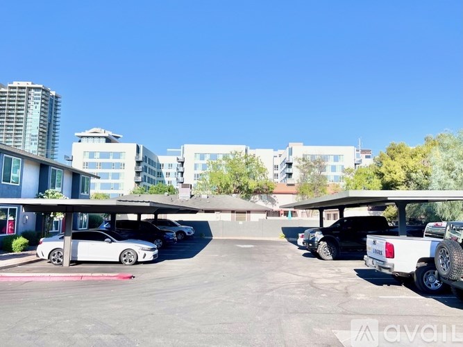 A parking lot with cars and buildings in the background.