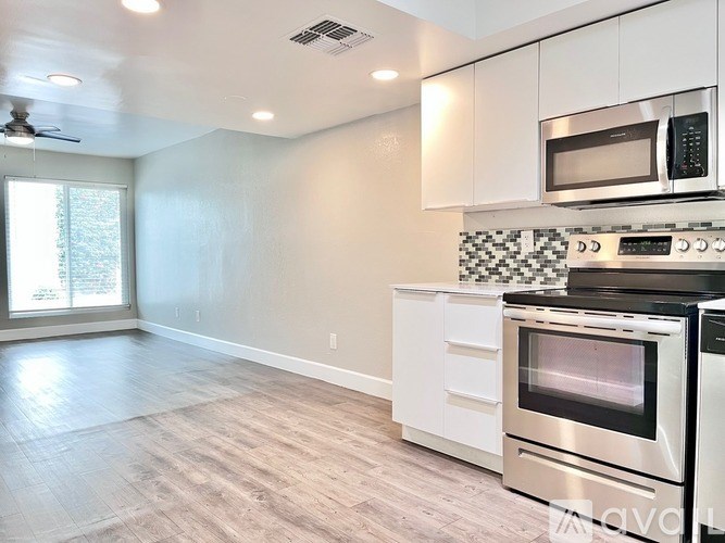 A kitchen with a stove top oven and microwave.