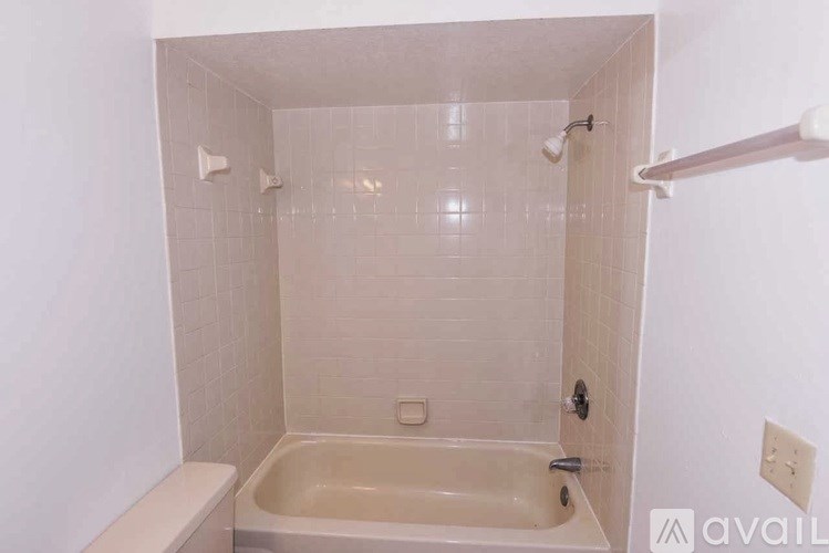 A white bathroom with a bathtub and a shower.