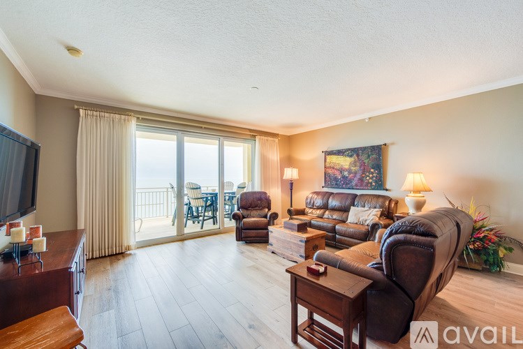 A living room with a brown leather couch and a wooden coffee table.