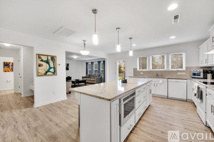 A modern kitchen with white cabinets and a central island.