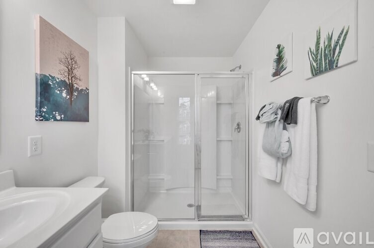 A bathroom with a white tub, toilet, and sink.