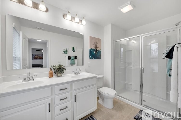 A bathroom with a white sink and a white toilet.