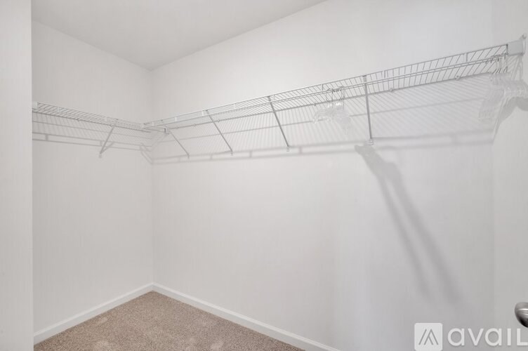 A white wall with a metal rack on it.