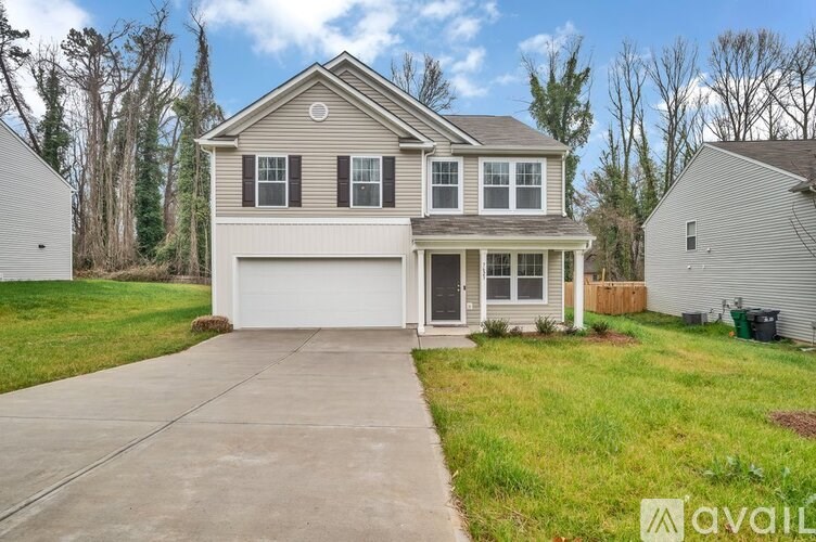 A two-story house with a garage is for sale.