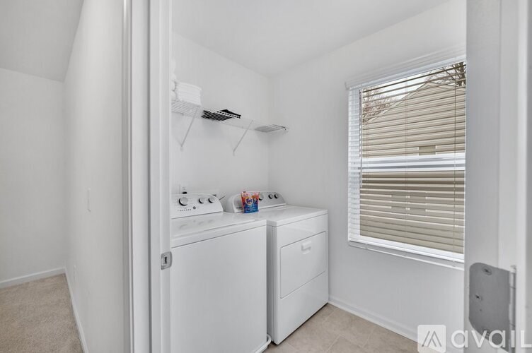 A small laundry room with a washer and dryer.