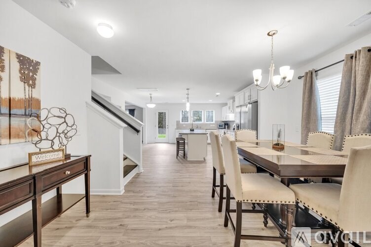 A modern dining room with a wooden table and chairs.