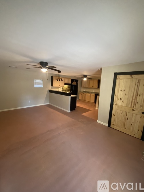 A room with a ceiling fan and a cabinet.