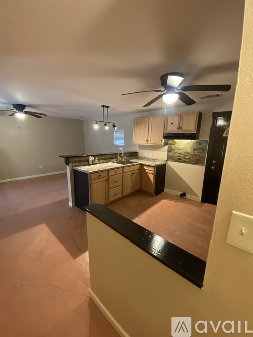 A kitchen with a fan and a countertop.