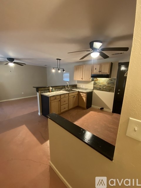 A kitchen with a fan and a countertop.