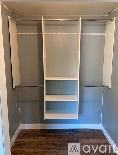 A white closet with shelves and a hanging rod.