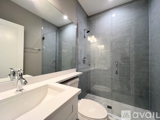 A bathroom with a white sink and toilet.