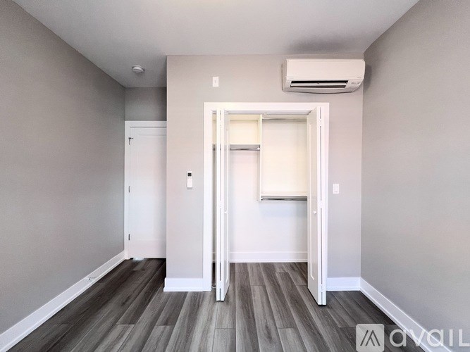 A room with a white door and a window.