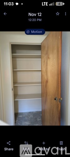A wooden door with a shelf underneath it.