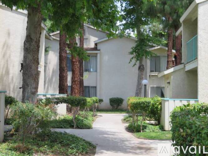 A residential area with apartment buildings and a walking path.