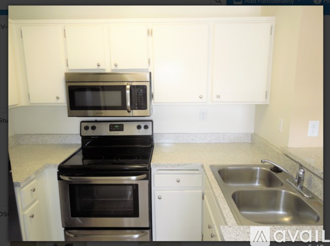A kitchen with a stove, oven, microwave, and sink.