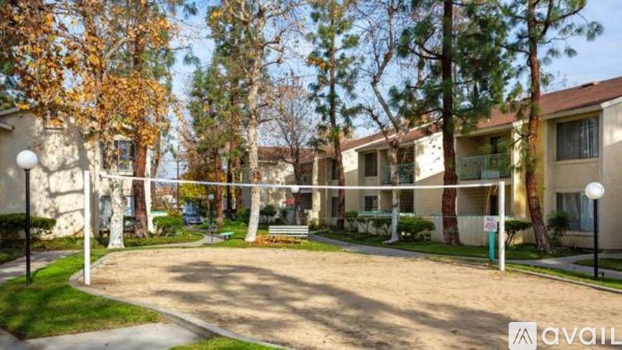 A sunny day at a residential area with apartment buildings and trees.