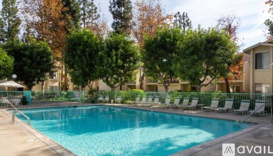A pool surrounded by trees and chairs with the word "available" on the bottom right.