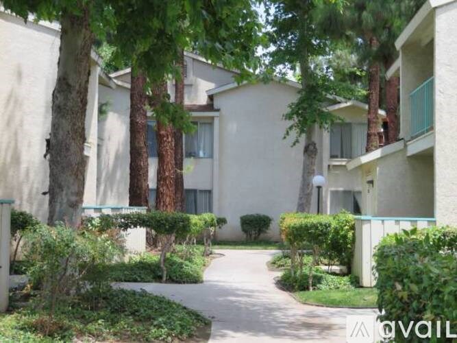 A residential area with apartment buildings and a walking path.