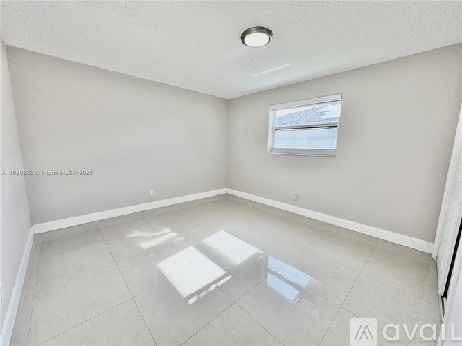 A room with a window and a table in it.