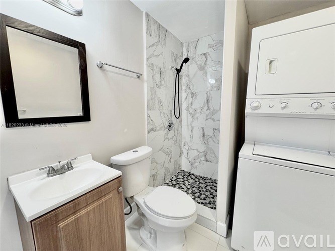 A bathroom with a toilet, sink, and shower.