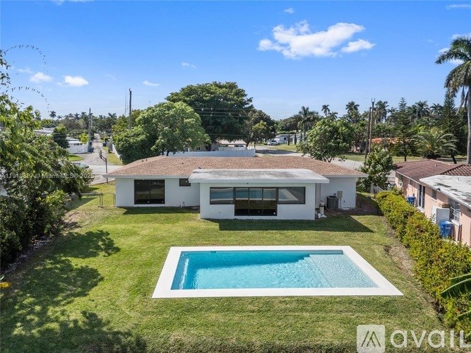 A white house with a pool in the backyard.