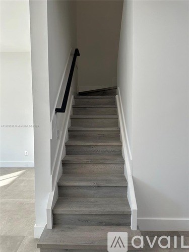 A staircase with wooden steps and white railings.
