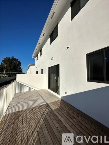 A modern building with a wooden deck in front.