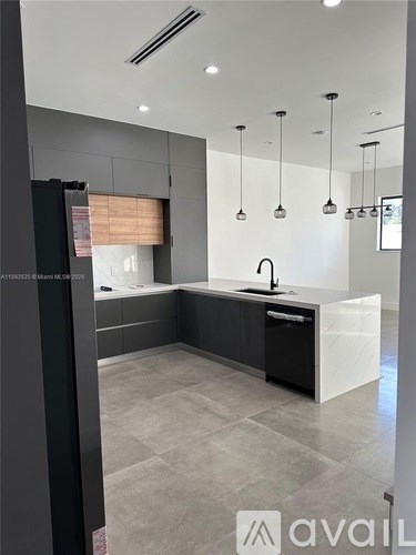 A modern kitchen with a black and white color scheme.