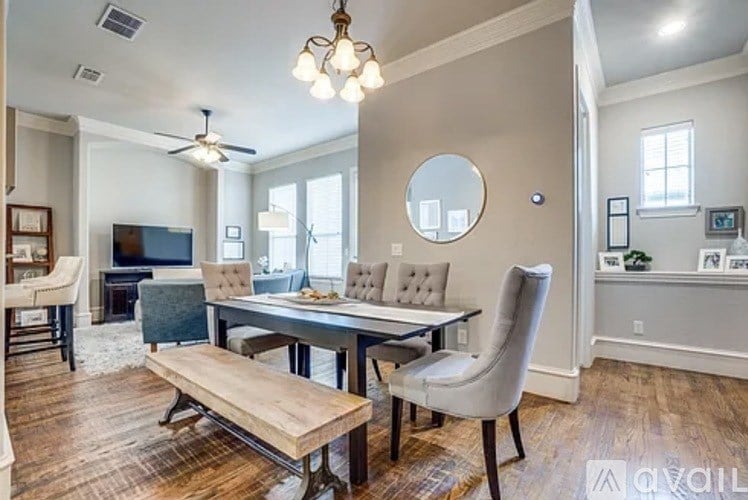 A dining room with a wooden table and chairs.