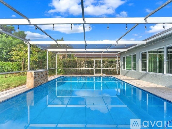 A pool under a white canopy with the logo "avail" on the bottom right.