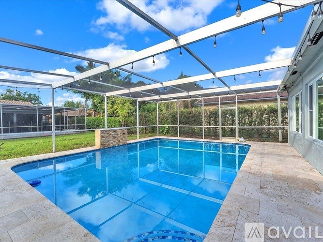 A pool enclosed by a glass wall and a metal frame.