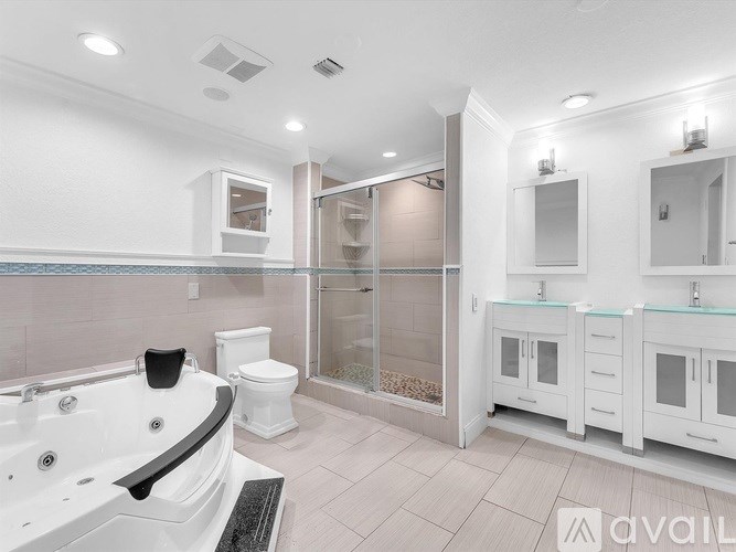 A bathroom with a white tub and sink.