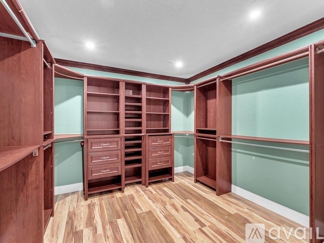 A room with wooden shelves and drawers.