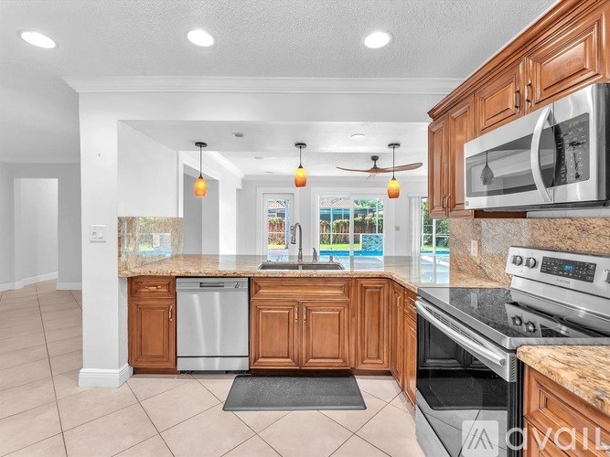 A kitchen with wooden cabinets and granite countertops.