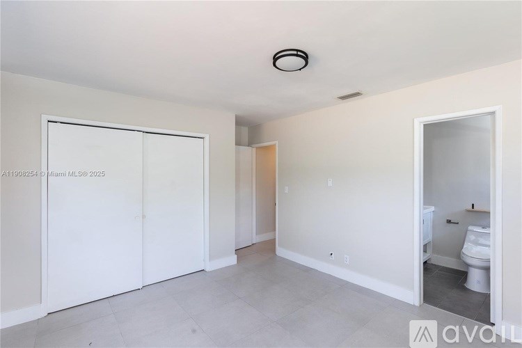 A white room with a toilet in the corner.