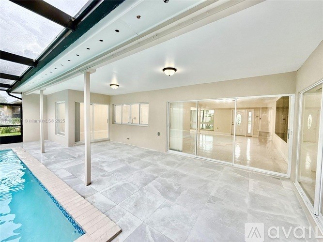 A large indoor swimming pool with a glass ceiling.