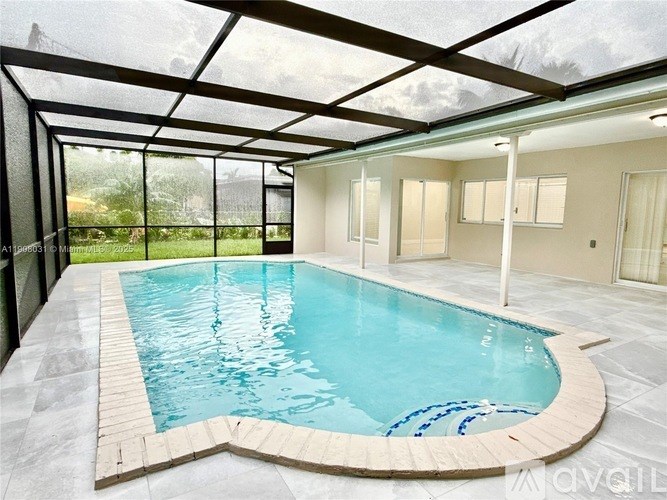 A swimming pool inside a room with a glass ceiling.