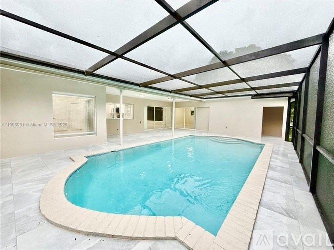 A large indoor swimming pool with a glass ceiling.