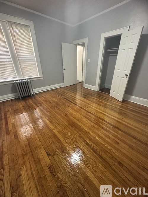 A room with wooden flooring and white doors.