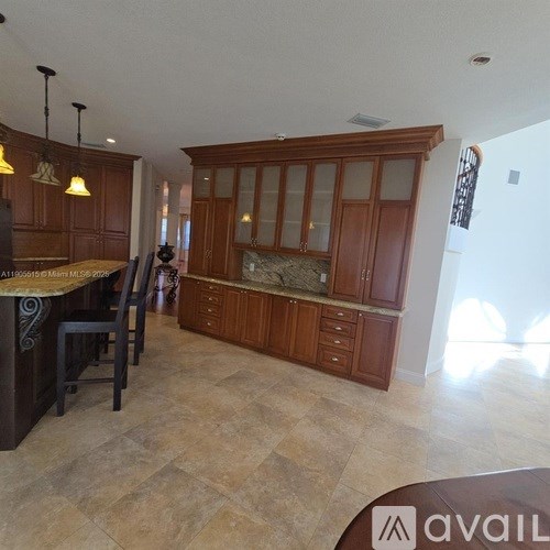 A kitchen with wooden cabinets and a countertop.