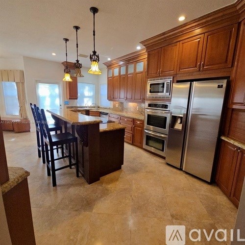 A kitchen with wooden cabinets and a granite countertop.
