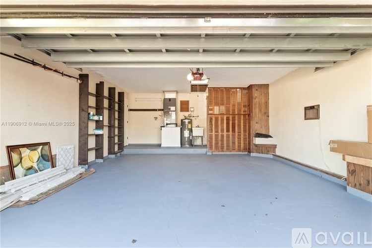 A spacious room with a white ceiling and a wooden partition on the right side.
